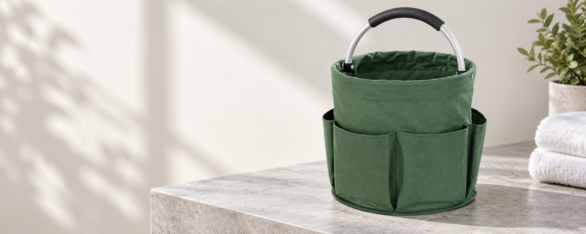 Product styling illustration of the green organizer basket on a light stone bench